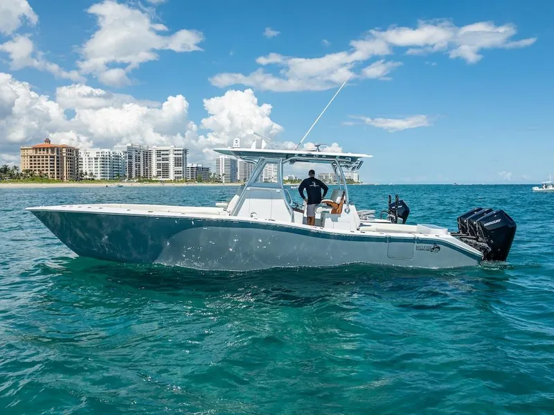 Slide: The Image of 2025 Billfish 39 Center Console boat on ocean, clear sky, cityscape background. - 9