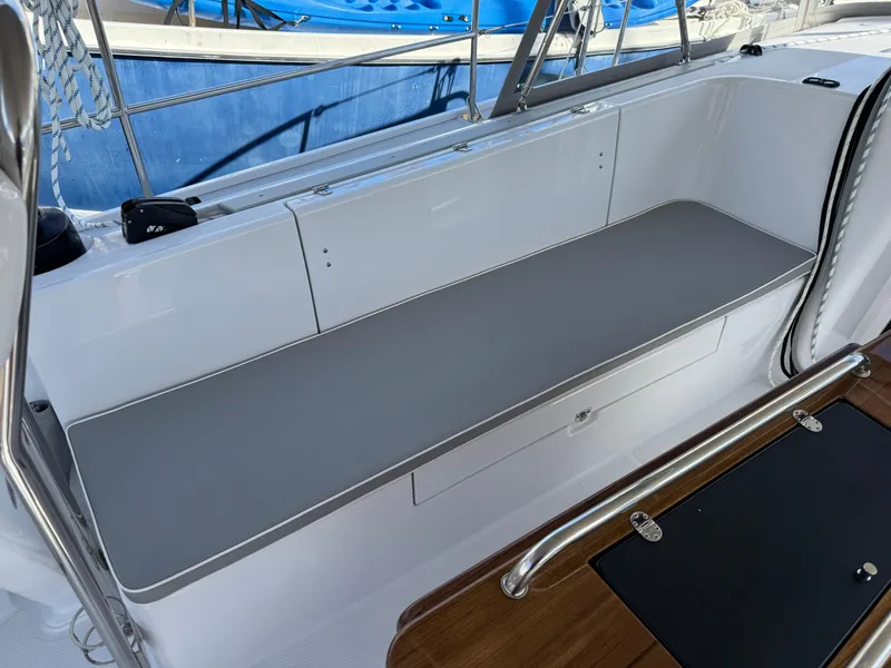 Slide: The Image of 2025 Catalina 426 yacht seating area with gray cushion and stainless steel railing. - 19