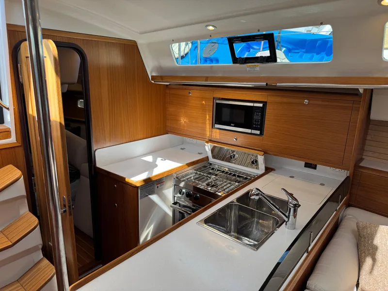 Slide: The Image of Modern kitchen in 2025 Catalina 426 yacht with wood cabinetry and stainless steel appliances. - 43