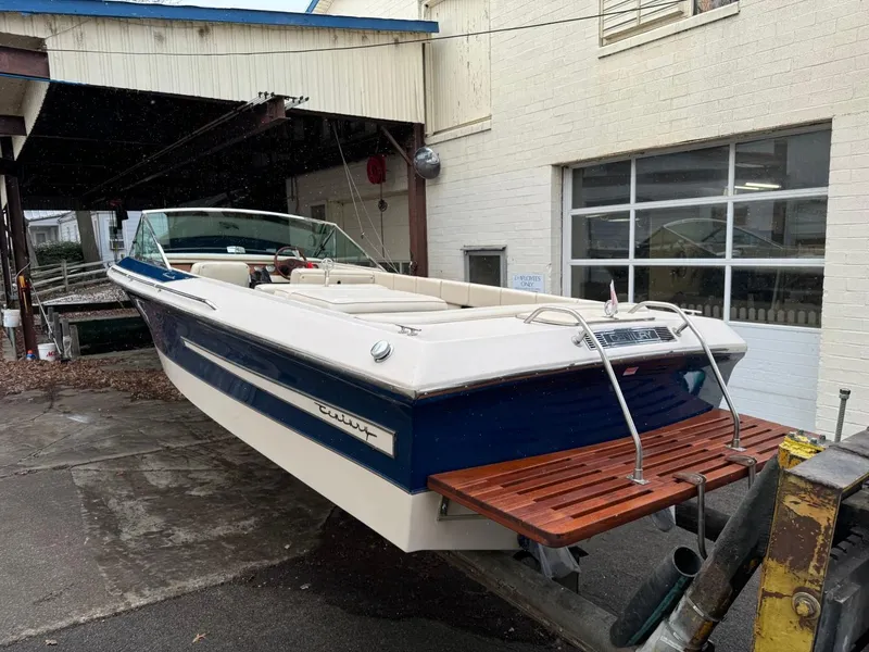 Slide: The Image of 1998 Century Coronado boat on trailer near a building. - 11