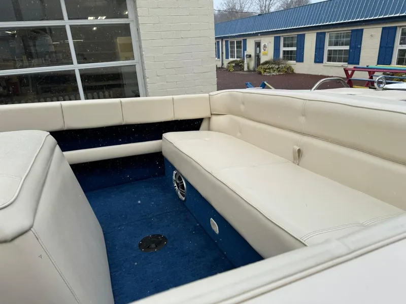 Slide: The Image of 1998 Century Coronado boat interior with white seating and blue carpet. - 13