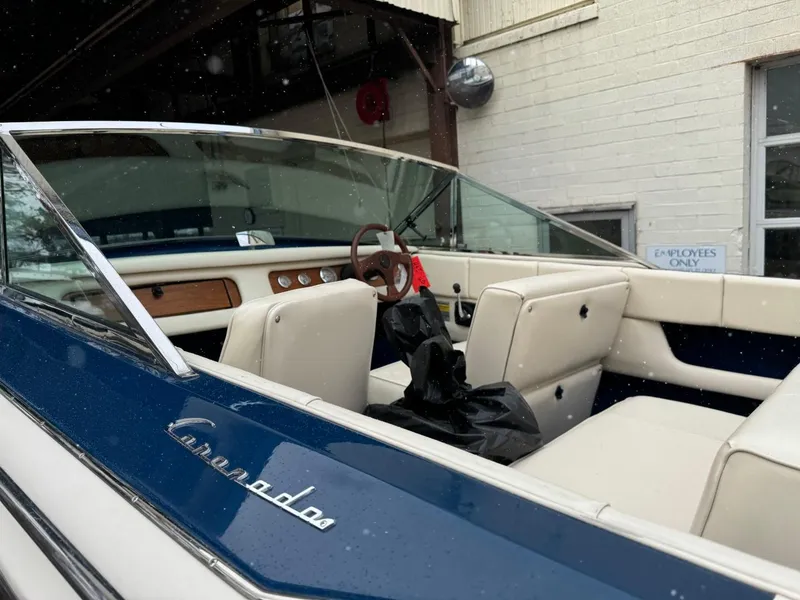 Slide: The Image of 1998 Century Coronado boat with white leather interior and wooden dashboard. - 14