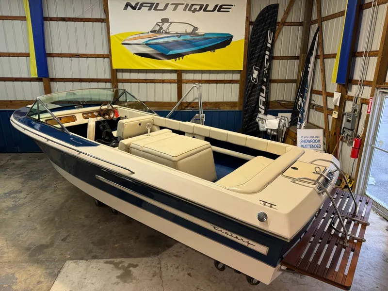 Slide: The Image of 1998 Century Coronado boat in showroom with Nautique signage. - 16