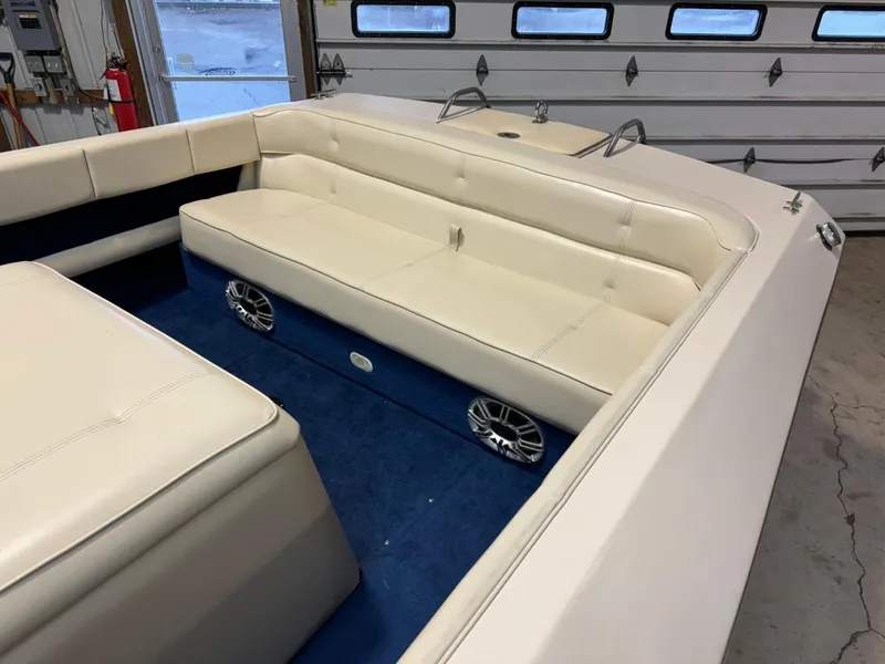 Slide: The Image of 1998 Century Coronado boat interior with white seating and blue carpet. - 18