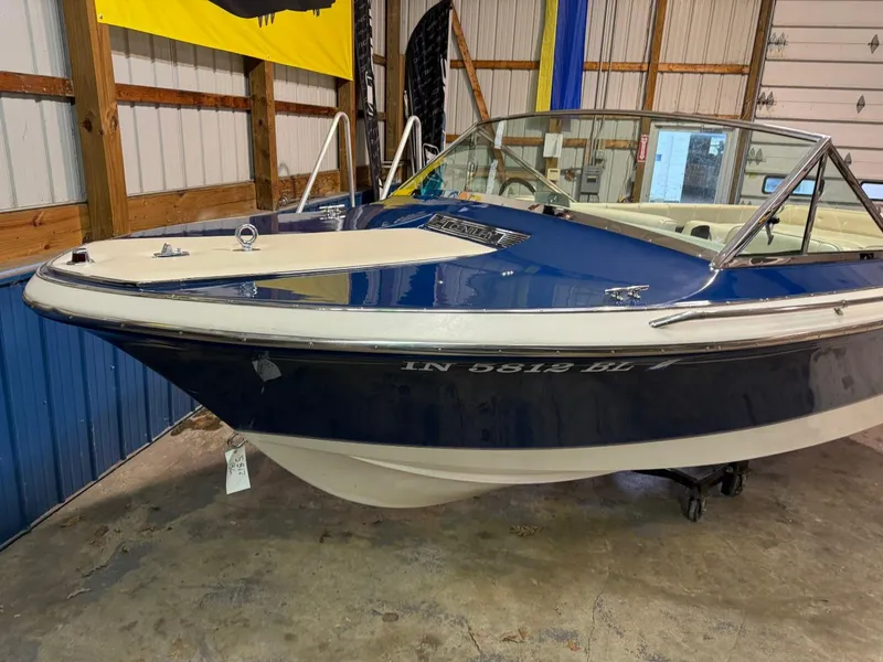 Slide: The Image of 1998 Century Coronado boat in a garage, blue and white exterior. - 20