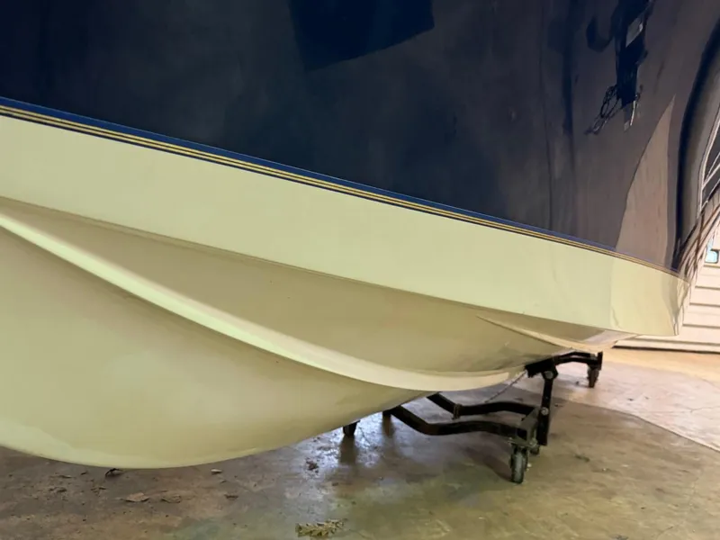 Slide: The Image of 1998 Century Coronado boat hull on trailer in garage. - 22