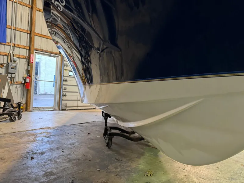 Slide: The Image of 1998 Century Coronado boat in a garage, showing hull and trailer. - 23