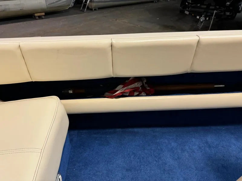 Slide: The Image of 1998 Century Coronado boat interior with beige seating and blue carpet. - 28