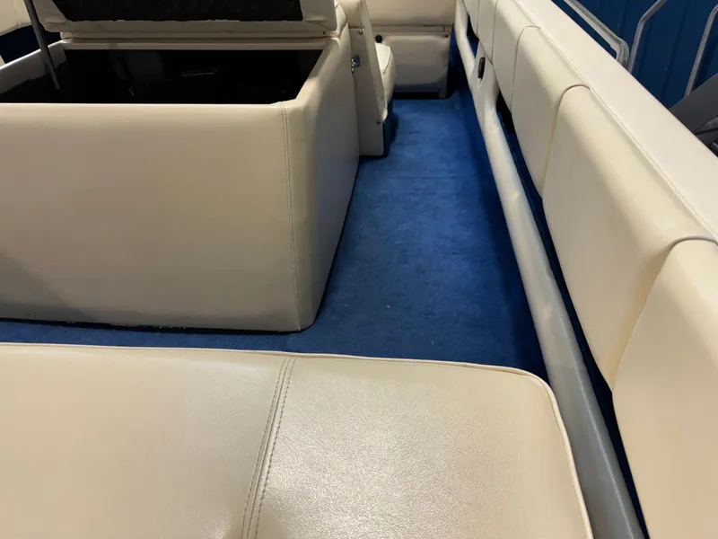 Slide: The Image of Interior of a 1998 Century Coronado boat with white leather seats and blue carpet. - 29