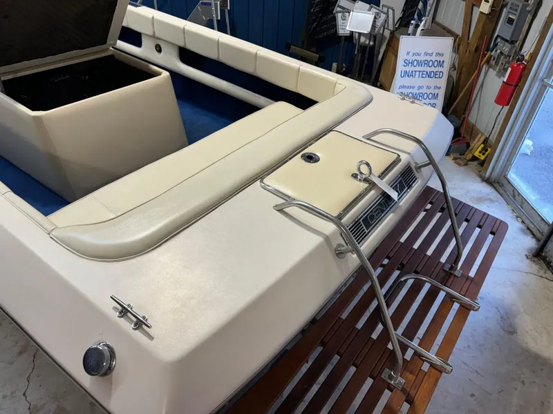 Slide: The Image of 1998 Century Coronado boat interior with white seating and wooden swim platform. - 33