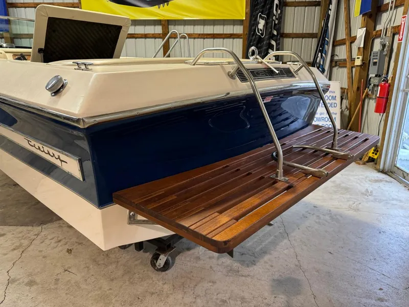 Slide: The Image of 1998 Century Coronado boat with wooden swim platform in a garage setting. - 34