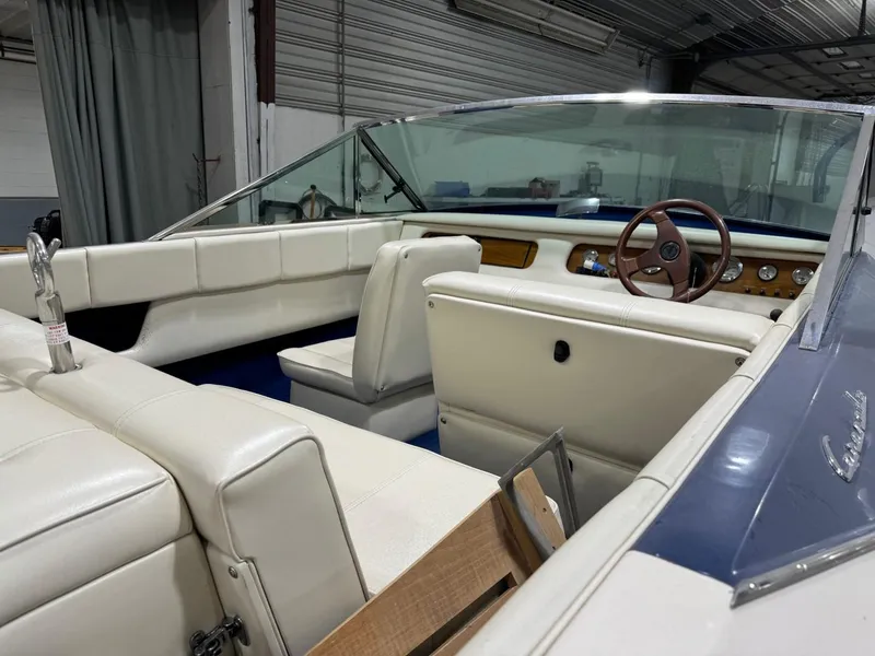 Slide: The Image of Interior of a 1998 Century Coronado boat with white leather seats and wooden dashboard. - 4