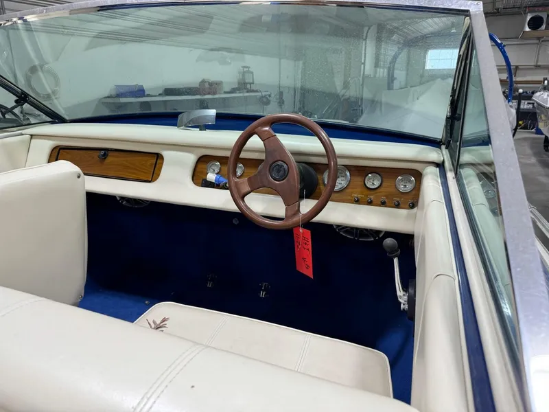 Slide: The Image of 1998 Century Coronado boat interior with wooden steering wheel and classic dashboard. - 5