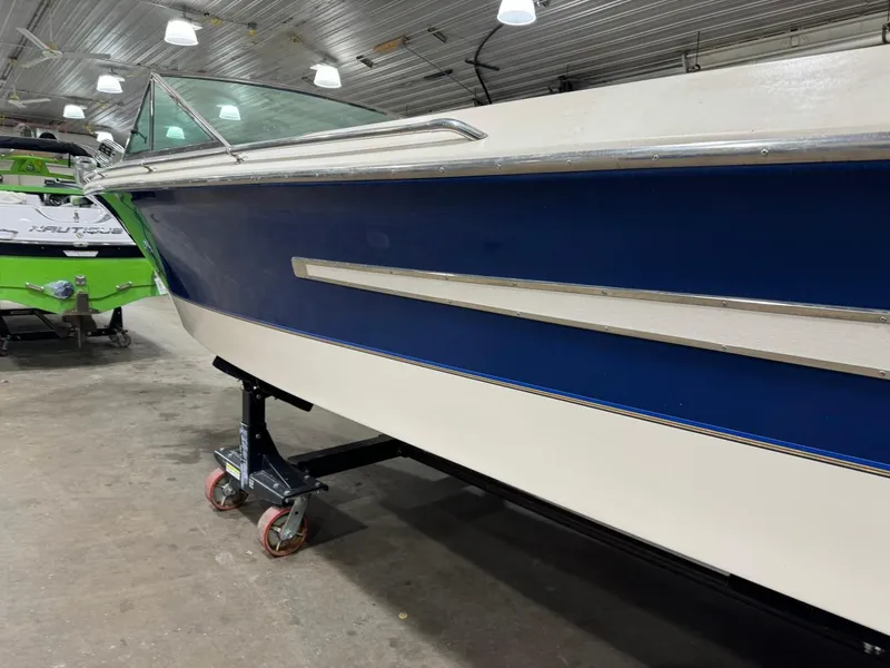 Slide: The Image of 1998 Century Coronado boat in a garage, blue and white exterior. - 7