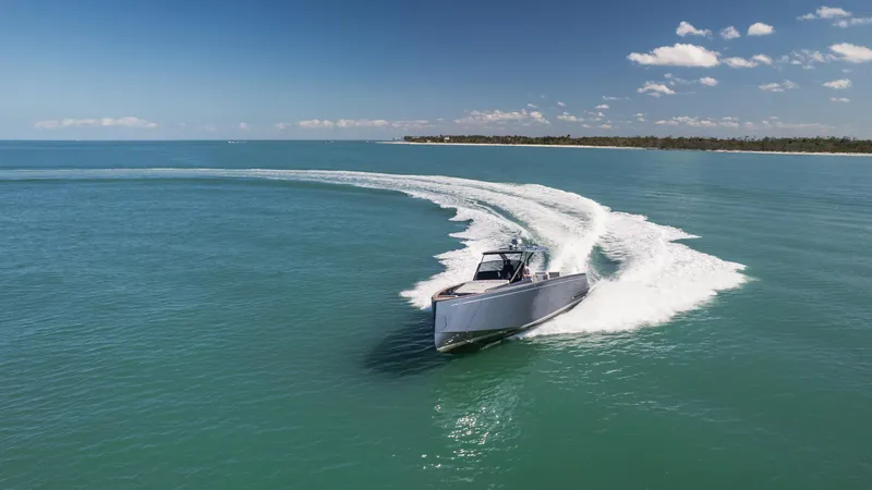 Slide: The Image of 2025 Pardo Yachts P43 cruising on open water under a clear blue sky. - 15