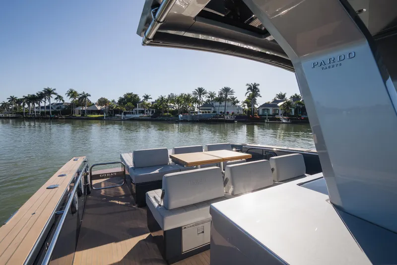 Slide: The Image of 2025 Pardo Yachts P43 on serene water, featuring luxurious seating and sleek design. - 29