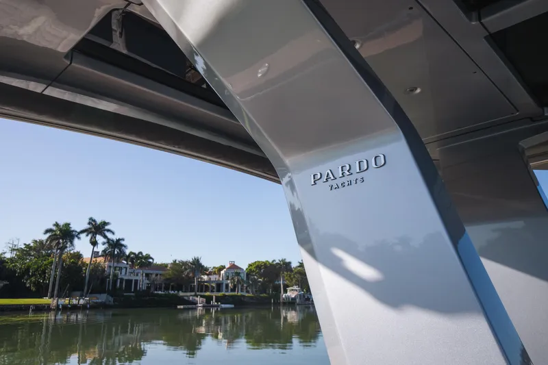 Slide: The Image of 2025 Pardo Yachts P43 docked by a serene waterfront with palm trees. - 30