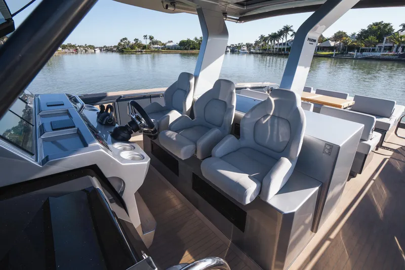 Slide: The Image of 2025 Pardo Yachts P43 interior with modern helm and luxurious seating on a serene waterway. - 31