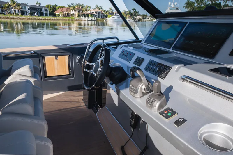 Slide: The Image of Helm of 2025 Pardo Yachts P43 with modern controls and scenic waterfront view. - 33