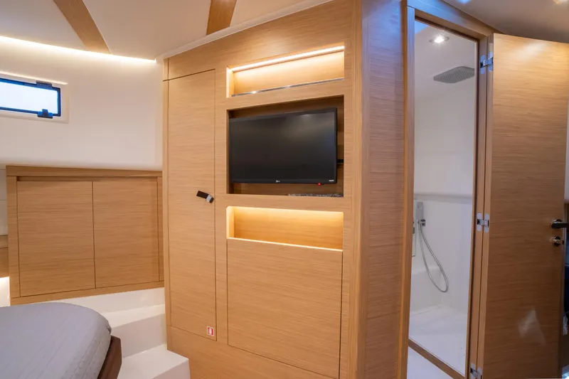 Slide: The Image of Luxurious interior of 2025 Pardo Yachts P43 with modern wood finish and built-in TV. - 38
