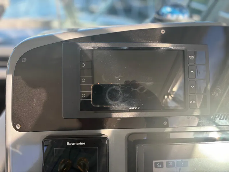 Slide: The Image of Dashboard of a 2000 Pursuit 3400 Express boat with navigation equipment. - 12