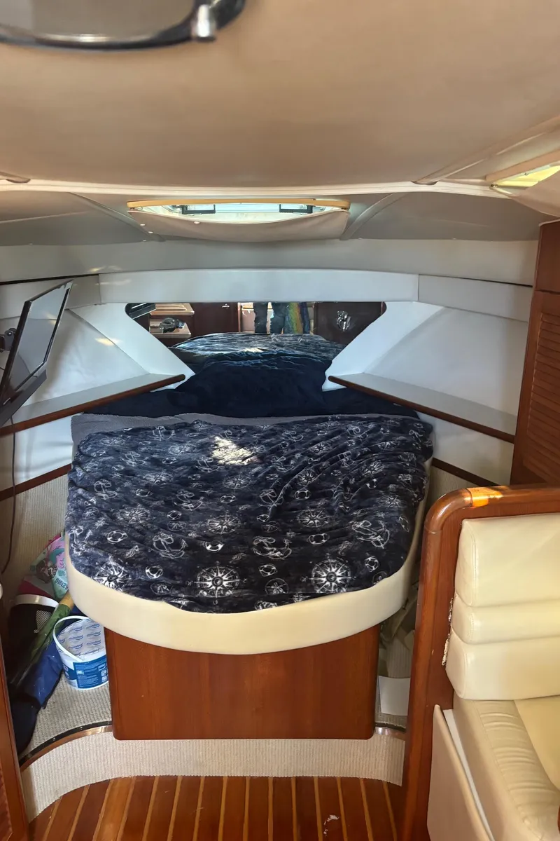 Slide: The Image of Interior cabin of 2000 Pursuit 3400 Express boat with bed and seating area. - 26