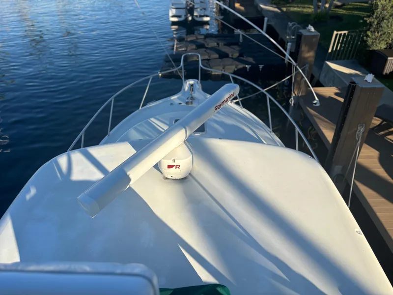 Slide: The Image of Pursuit 3400 Express boat with tower, docked by the water, 2000 model. - 5