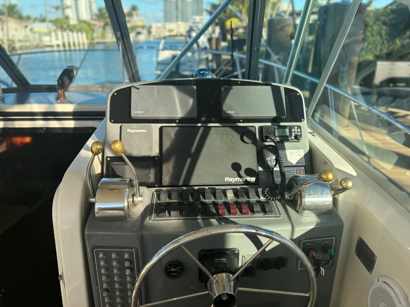Slide: The Image of Helm of 2000 Pursuit 3400 Express w/ Tower, featuring Raymarine electronics. - 9