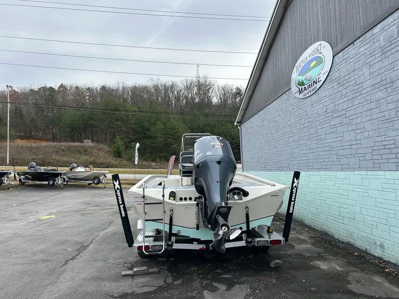 Slide: The Image of 2025 Xpress X23 Bay Lounge boat parked outside a marina. - 4