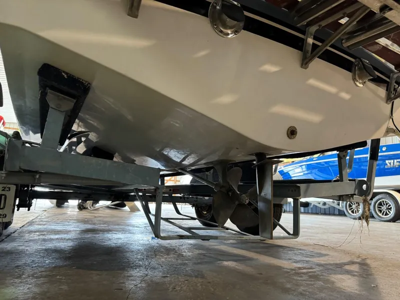 Slide: The Image of 1985 Coronado Cardel boat underside with propeller, on trailer in storage facility. - 11