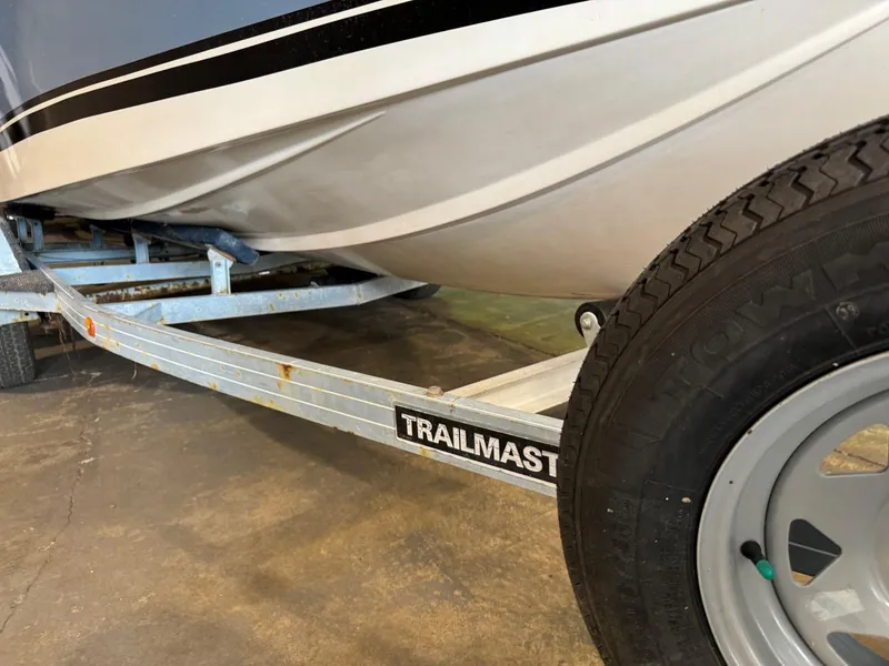 Slide: The Image of 1985 Coronado Cardel boat on Trailmaster trailer, close-up of hull and tire. - 13