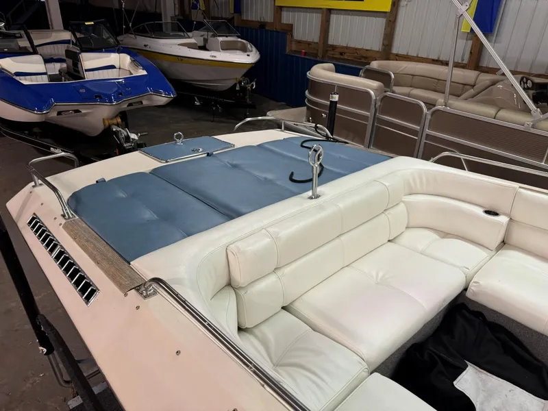 Slide: The Image of 1985 Coronado Cardel boat interior with white and blue seating in a showroom. - 16