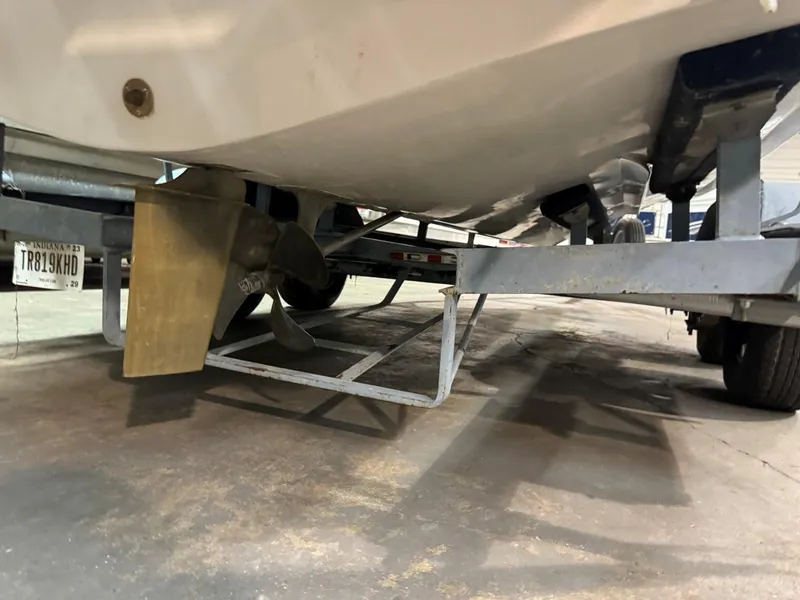 Slide: The Image of 1985 Coronado Cardel boat on trailer, showing propeller and rudder. - 19