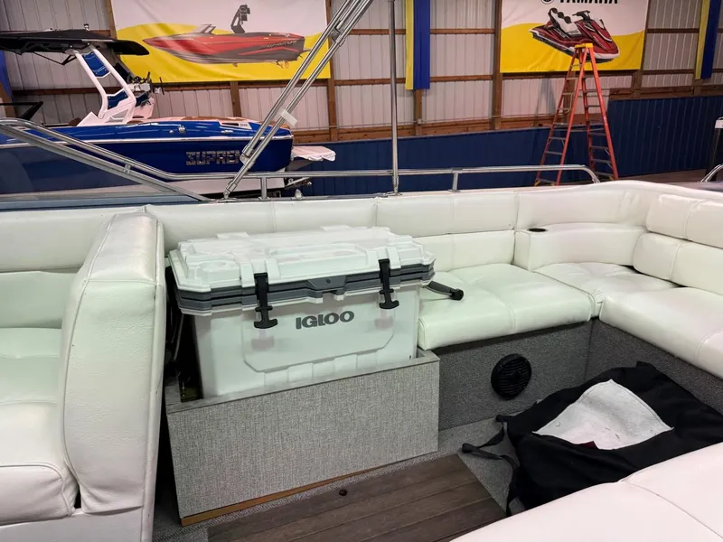 Slide: The Image of 1985 Coronado Cardel boat interior with white seating and Igloo cooler. - 22