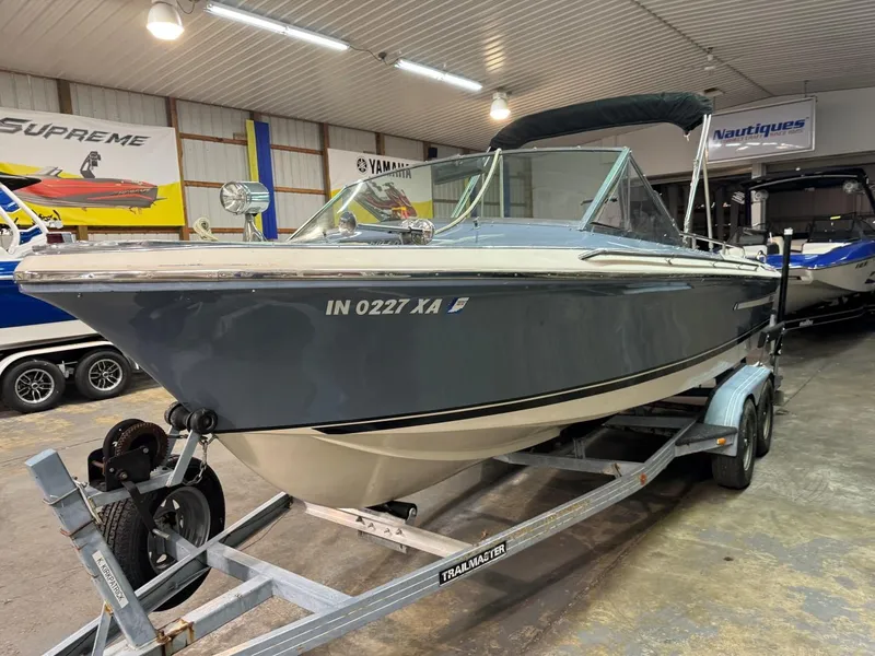 Slide: The Image of 1985 Coronado Cardel boat on trailer in indoor showroom. - 23