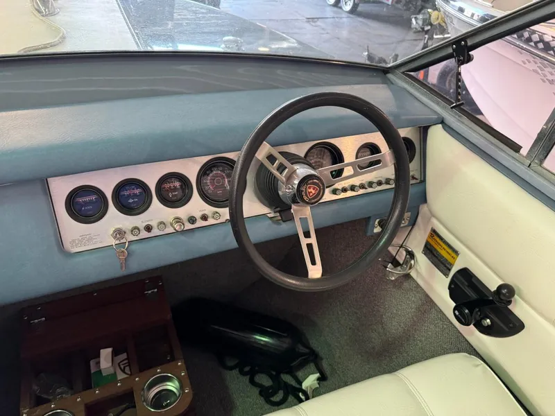 Slide: The Image of 1985 Coronado Cardel boat dashboard with steering wheel and instrument panel. - 25