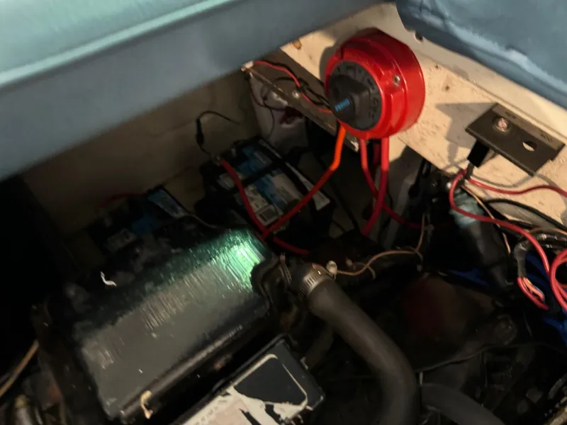 Slide: The Image of 1985 Coronado Cardel engine compartment with wiring and battery setup. - 28