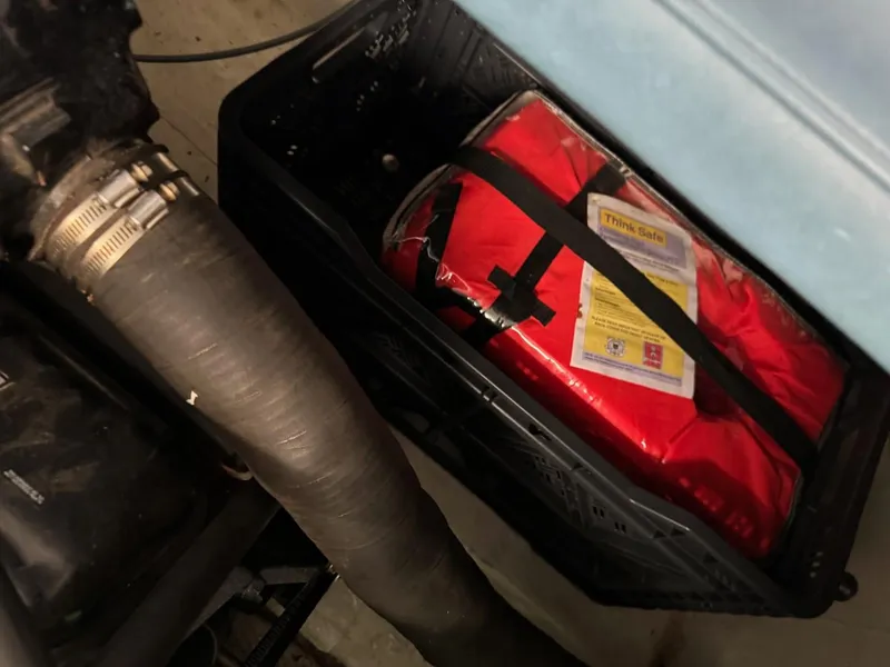 Slide: The Image of Red emergency kit in a black crate, next to a hose, Coronado Cardel 1985. - 29