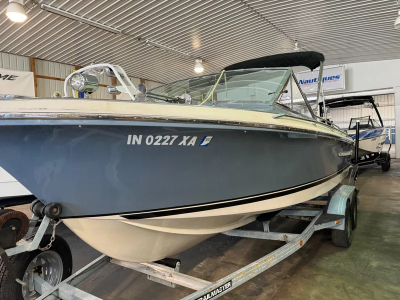 Slide: The Image of 1985 Coronado Cardel boat on trailer in indoor storage facility. - 31
