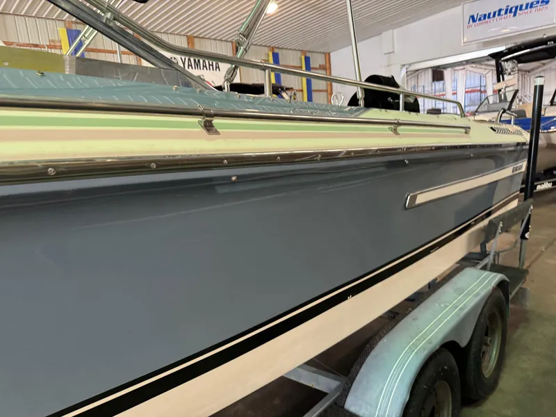 Slide: The Image of 1985 Coronado Cardel boat on trailer in indoor showroom. - 32