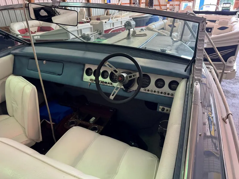 Slide: The Image of Interior of a 1985 Coronado Cardel boat with classic dashboard and steering wheel. - 4