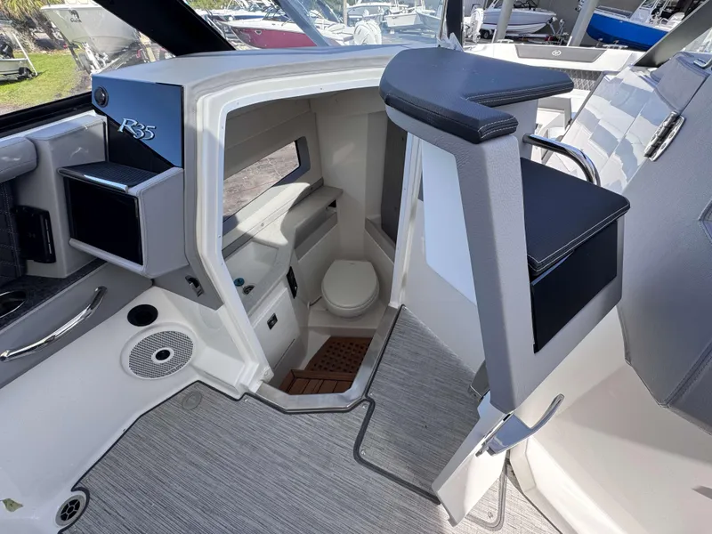 Slide: The Image of Interior of 2025 Cobalt R35 boat with modern seating and compact restroom. - 16