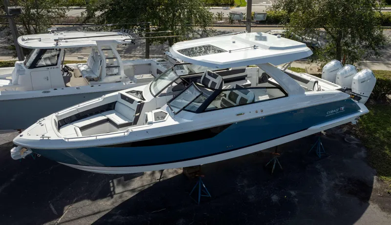 Slide: The Image of 2025 Cobalt R35 boat with sleek design, dual engines, and spacious seating. - 2