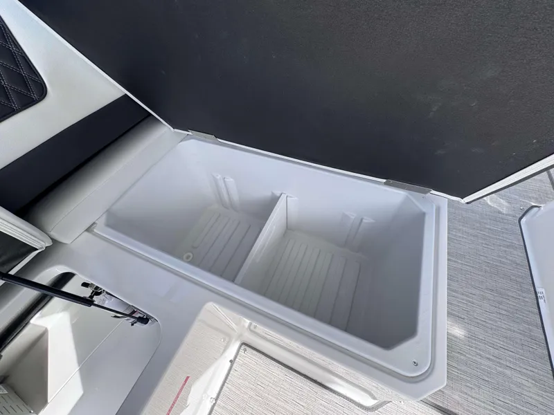 Slide: The Image of 2025 Cobalt R35 boat storage compartment, open and empty, with sleek interior design. - 25