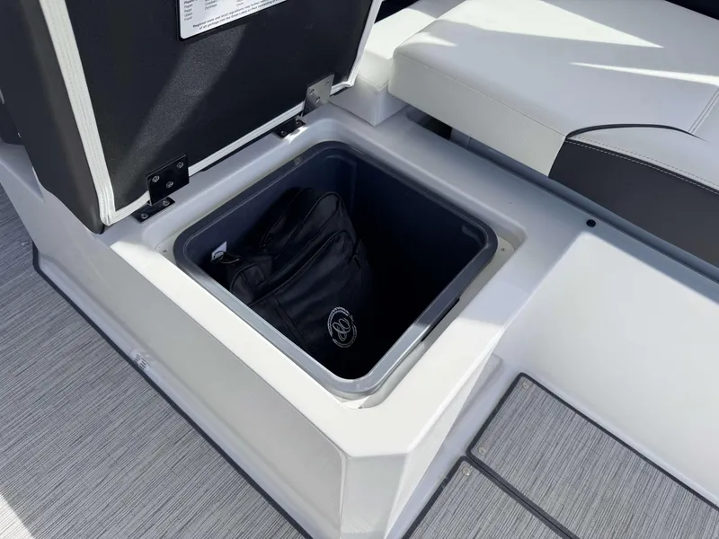 Slide: The Image of Storage compartment in 2025 Cobalt R35 boat with a black bag inside. - 26