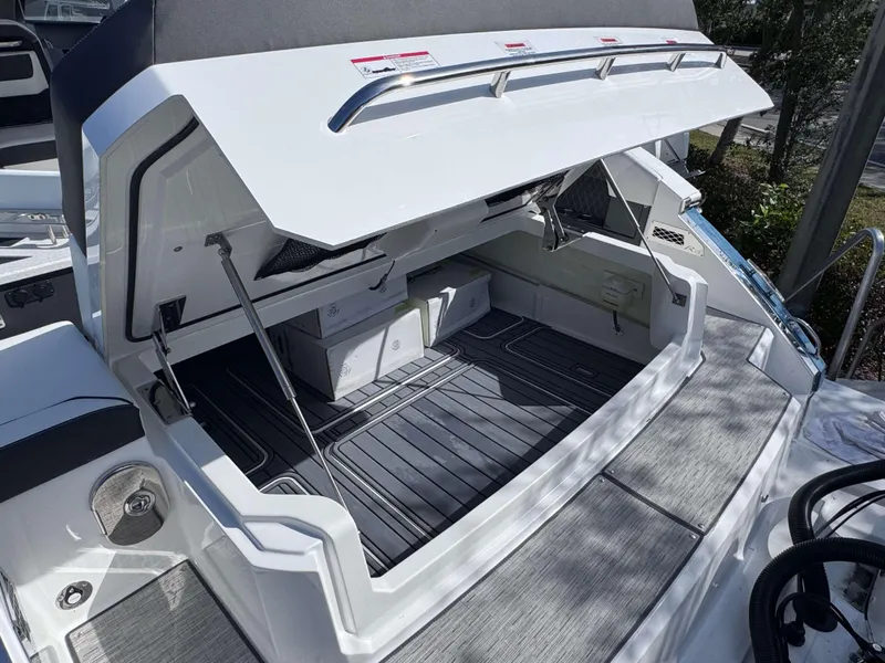 Slide: The Image of 2025 Cobalt R35 boat with open storage compartment, showcasing sleek design and ample space. - 37