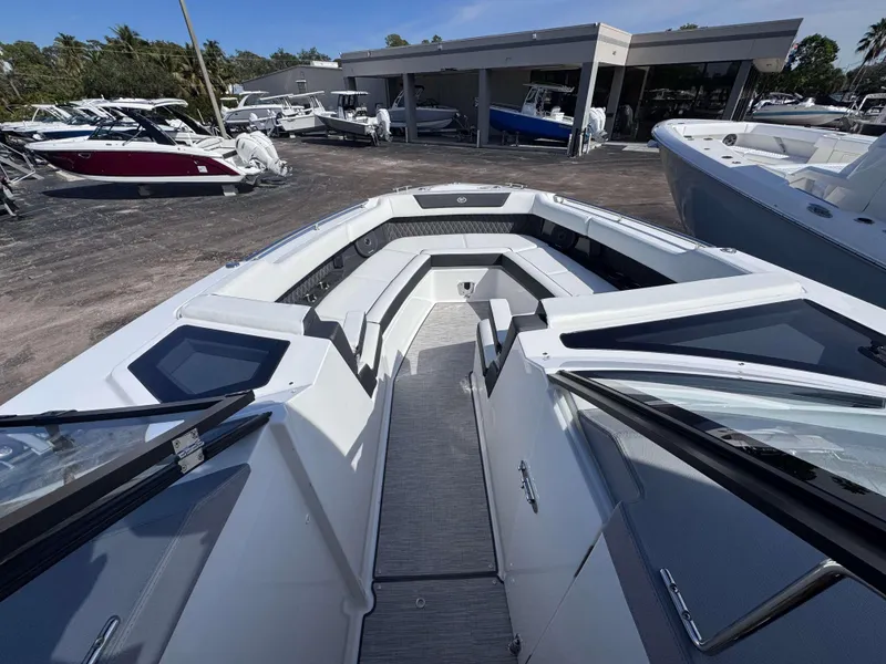 Slide: The Image of Cobalt R35 2025 boat interior with seating, docked at a marina. - 9