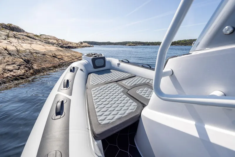 Slide: The Image of 2025 Highfield Sport 560 boat on water near rocky shore. - 17