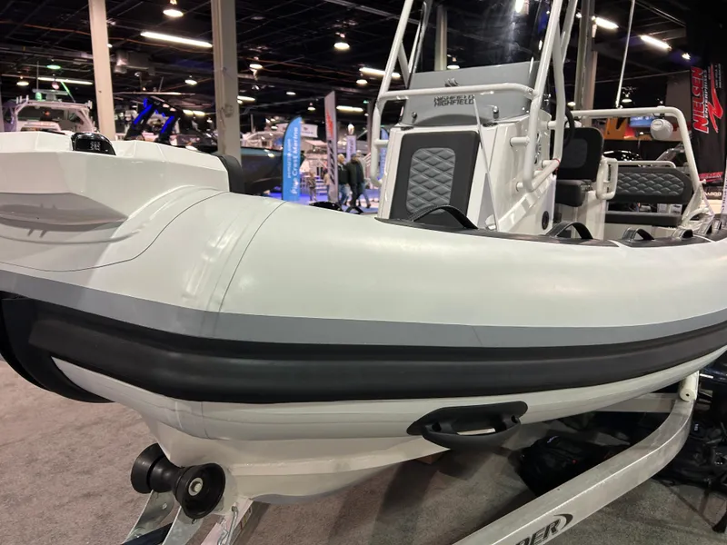 Slide: The Image of 2025 Highfield Sport 560 boat displayed indoors at a marine exhibition. - 9