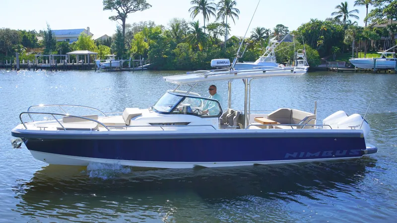 Slide: The Image of Nimbus T9 #165 boat cruising on a sunny river, 2025 model. - 0